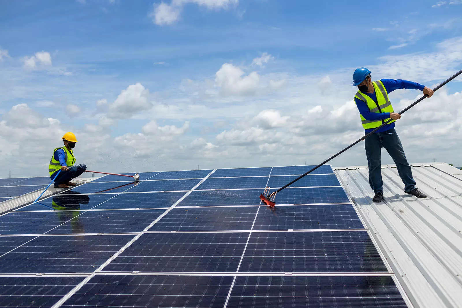 Workers Maintaining Solar Panels